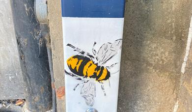 A bee painted on a fuse box