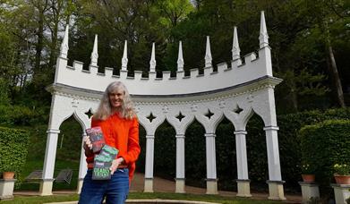 Rachel Sargeant with Gloucestershire Crime Series in front of the Exedra folly at Painswick Rococo Garden.