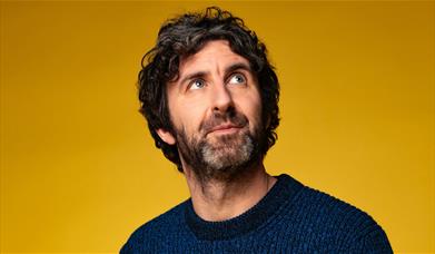 Mark Watson against a yellow background