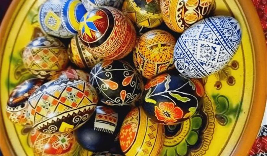 Brightly coloured painted eggs in a bowl